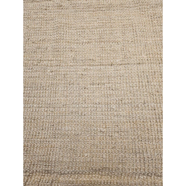 Simple, timeless, and beautifully understated, this oversize handwoven jute rug embodies the quiet elegance of natural...