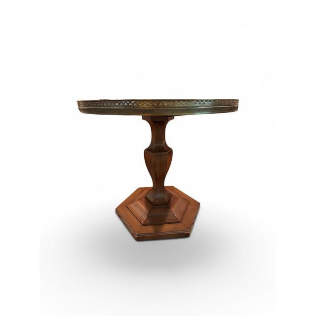 Empire-style guéridon pedestal table featuring a circular top with a pierced brass gallery. Light wear as shown on base....