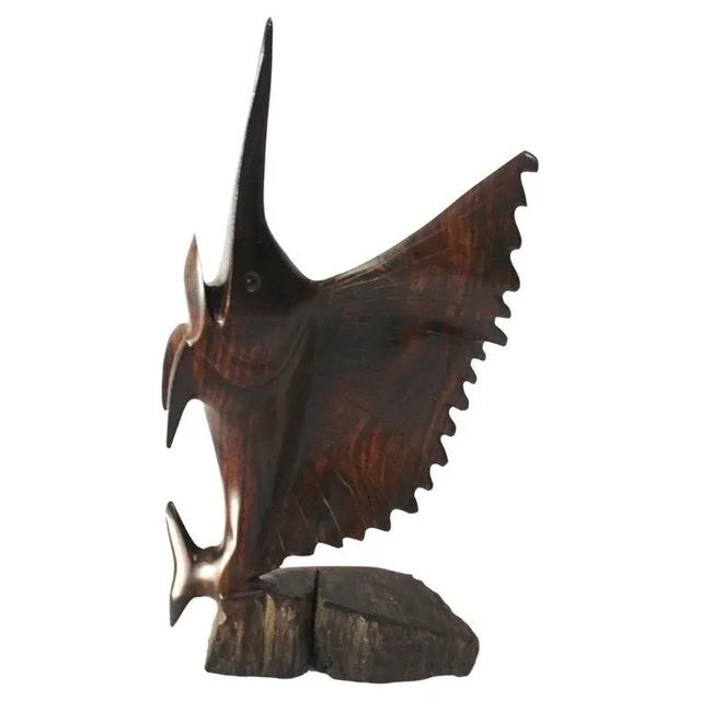 This stylish rosewood figure of a sailfish was created in Bali and it will make a subtle statement with its form and use...