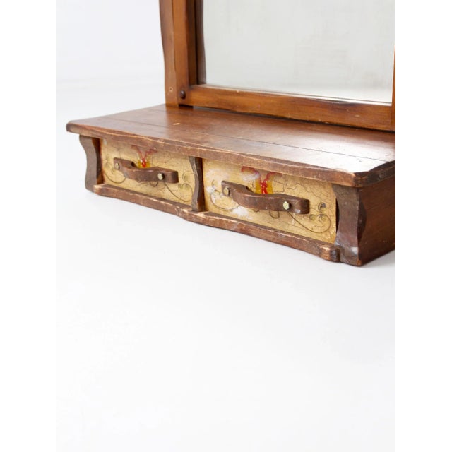 Vintage Monterey style dresser top vanity mirror with a hand painted wood frame and drawer base. The mirror swings within...