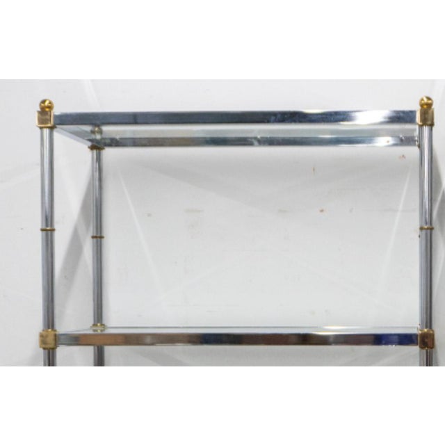 Pair of chrome and brass midcentury etageres in the style of Maison Jansen. Five shelves with faux bamboo details and...