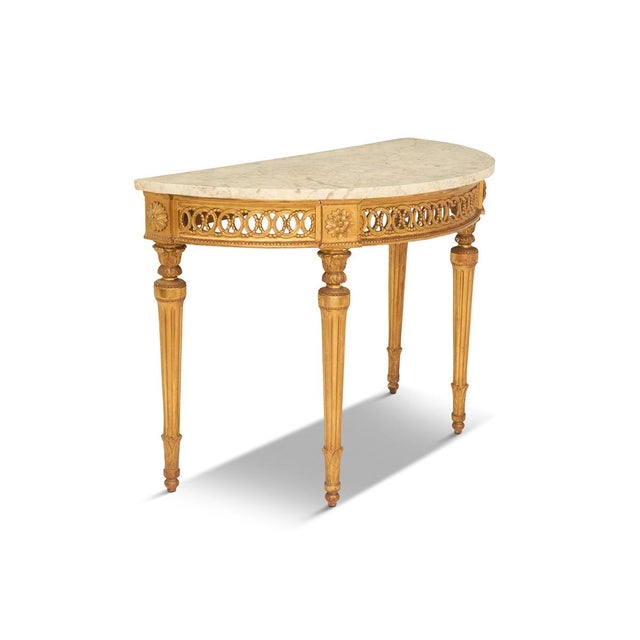 18th century, of demilune form, white-and-gray-veined marble top. Pierced frieze with beaded trim, raised on turned and...