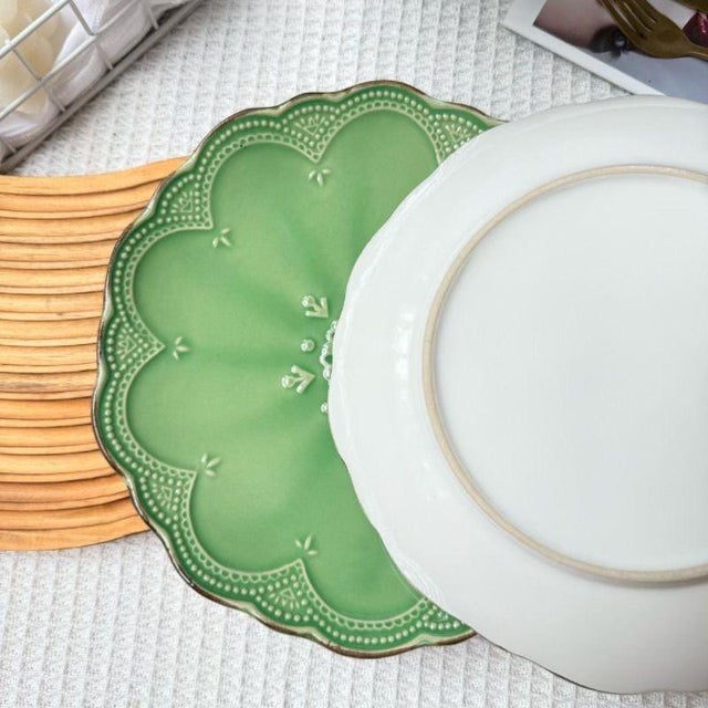 Crafted using a hand-carved relief technique, the plate features a floral outline, with three-dimensional flowers and...