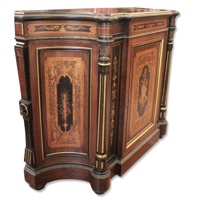 Renaissance Revival credenza in American rosewood with a sculpted, serpentine front. The intricate marquetry designs...
