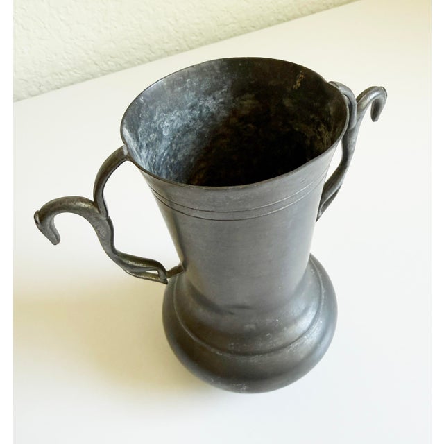 A wonderful Art Deco era vintage pewter vase featuring stylized greyhound handles. The piece is made of solid pewter with...