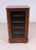 Victorian walnut music cabinet with a glazed front door opening to reveal sectional shelves for storing sheet music with...