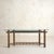 An Italian console table from the 1970s, crafted in natural bamboo and iron and topped with a trapezoidal glass surface....
