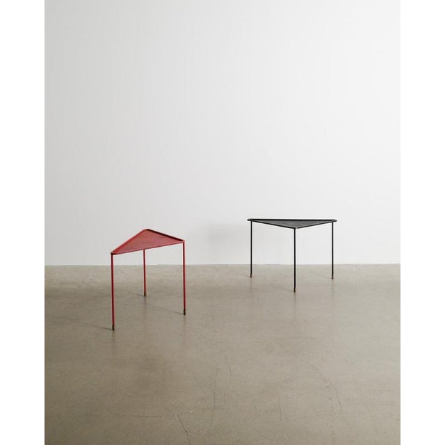 Rare pair of French mid century triangular side tables in black and red lacquered metal with decorative and patinated...