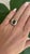 This stunning vintage ring from the 1960s features an 18-carat yellow gold band adorned with an oval Ceylon blue sapphire...