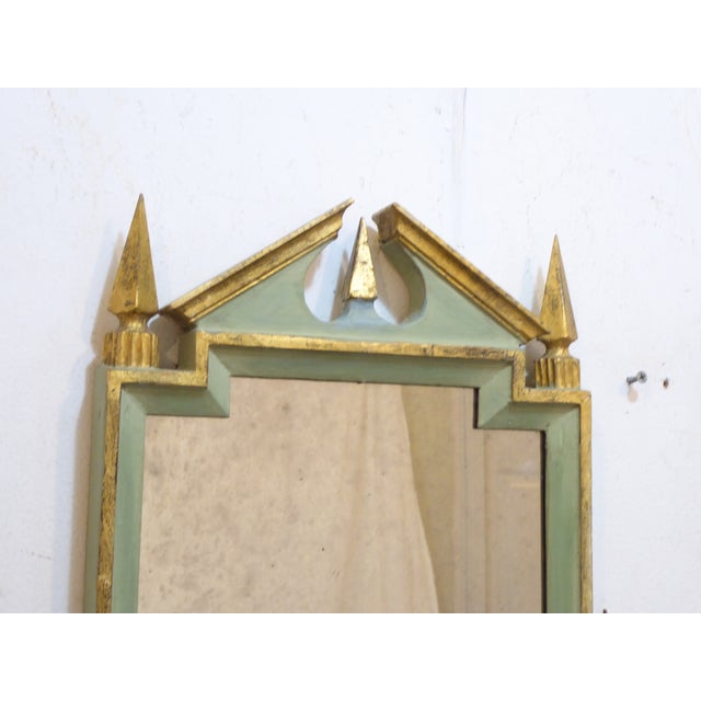 This small, painted frame has a distressed mirror with clouding and speckling. It measures 18.25"H x 11.75"W.