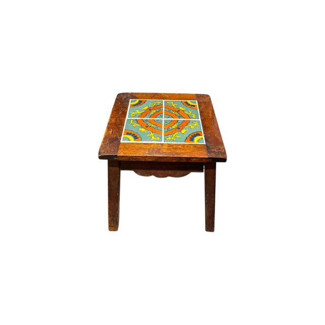 This charming wood side table features a hand-laid mosaic tile top with vibrant, intricate detailing that adds character...