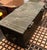 An antique small cast bronze lidded casket or strongbox with a wood-lined interior, decorative iron strap-work, side ring...