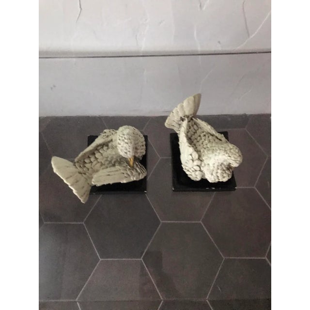 In the style of famed Italian artist Amilcare Santini (1910-1975) this pair of carved wood birds resting on a square black...