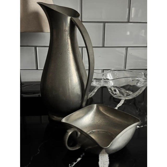 Mid-century sculptural pewter pitcher with original matching basin, handmade in Holland. Elegant modern form with...