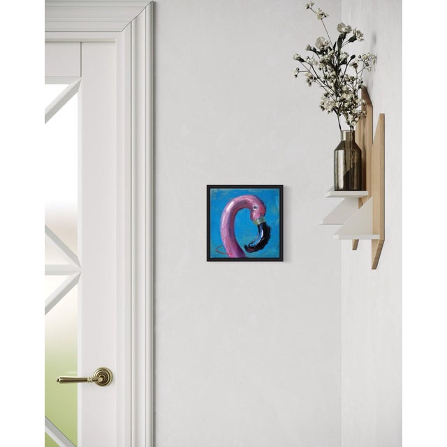 This artwork features a close-up depiction of an inflatable flamingo against a vibrant blue background, capturing the...