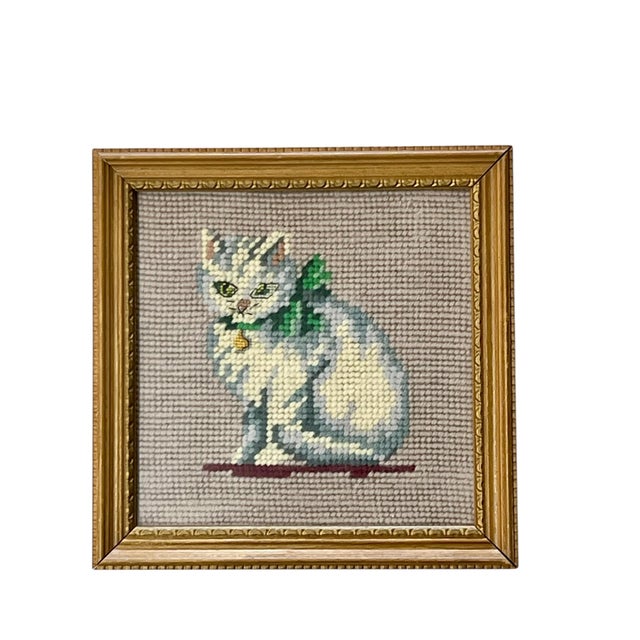 The sweetest pair of light wood framed needlepoint cat or kitten portraits. The cats each have bows around their necks....