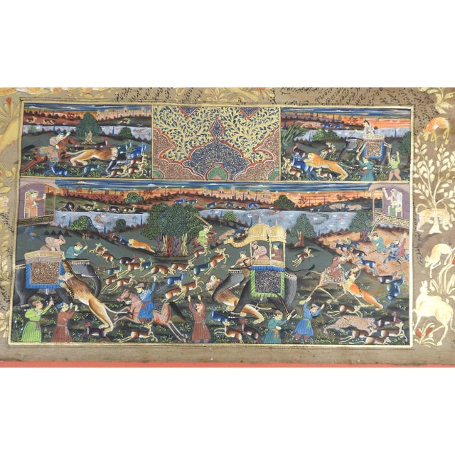 19th century gouache on paper Mughal miniature hunting painting on illuminated book page. Lions, tigers, elephant, camel,...