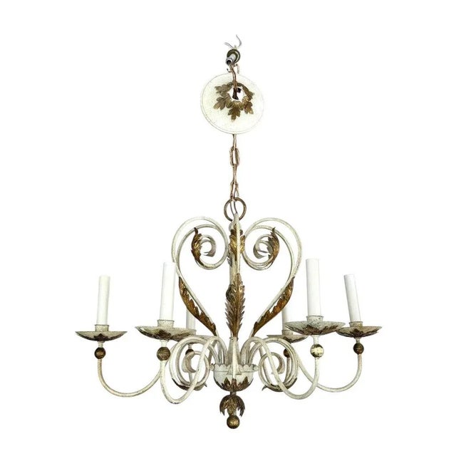 Shabby chic white and gold washed chandelier. Gorgeous six-arm chandelier accented with gold acanthus style fern leaves.