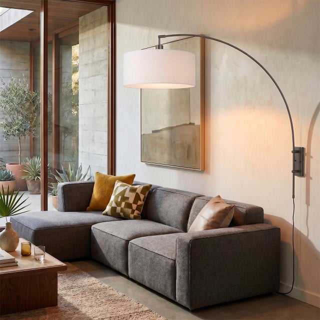 The Span Wall Mounted Arc Lamp is a Peter Morelli-designed modern lighting piece, featuring a black nickel steel body and...