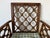 Elegant vintage Chinese Chippendale-style armchair featuring a beautifully crafted open fretwork geometric lattice back...