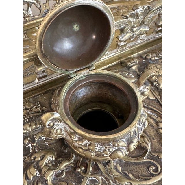 Magnificent antique cast brass double inkwell with an integrated letter holder, richly detailed in the Baroque or early...