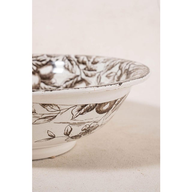Large vintage brown transferware bowl featuring an all-over pastoral transfer-printed design with a scalloped rim and warm...