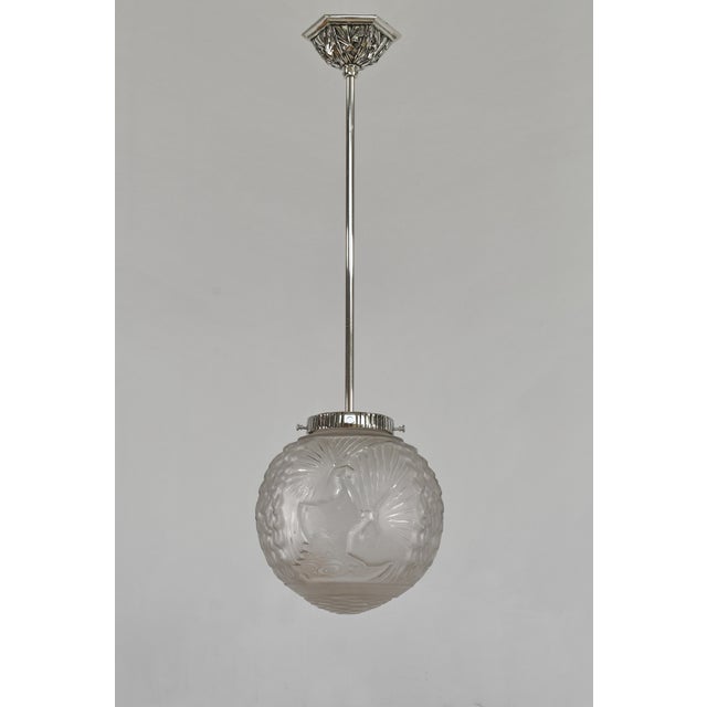 Muller frères & la Lustrerie Bruxelloise A 1925-1935 Franco-Belgian art deco pendant light depicting peacocks. Made in...