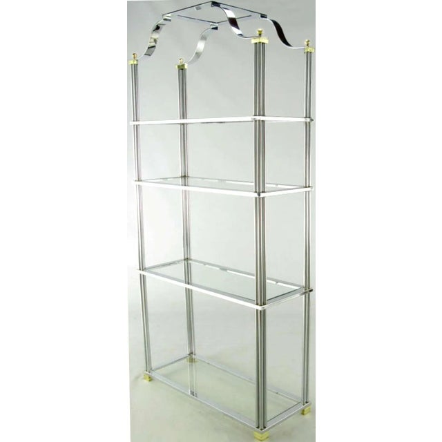 Chrome and brass four shelf etagere with excellent understated details. Each shelf is supported by 12 chromed bars with...