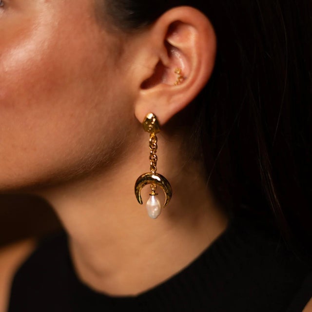 Step into elegance with the Mystic Moonlight Pearl Gold Earrings, a unique handmade design that captures the enchanting...