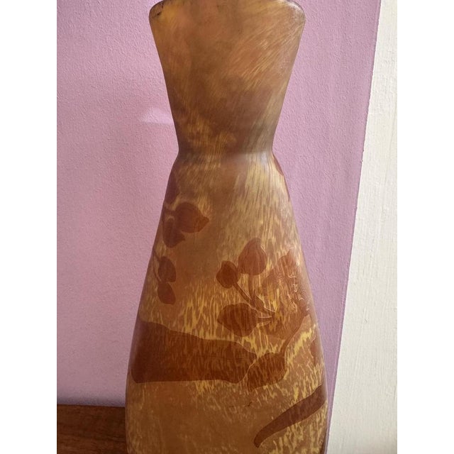 Decorative Gallé cameo glass vase in an elegant baluster shape. Multi-layered glass in warm amber and cognac tones with a...