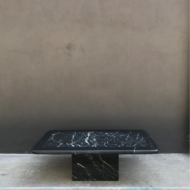 Vintage postmodern black marble coffee table with curved, framed stone top resting on a bold plinth. Table is two pieces:...