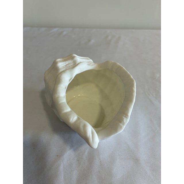 This vintage conch shell dish is one of our vintage finds, handmade in the Philippines from fine bone china. The matte,...