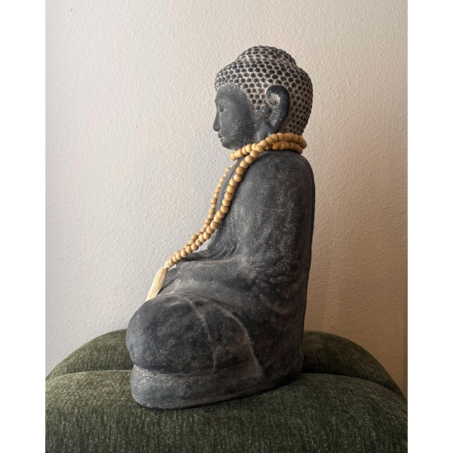 The Arhaus Seated Buddha with Beads is a substantial decorative sculpture crafted in India from dark gray cast stone. Its...
