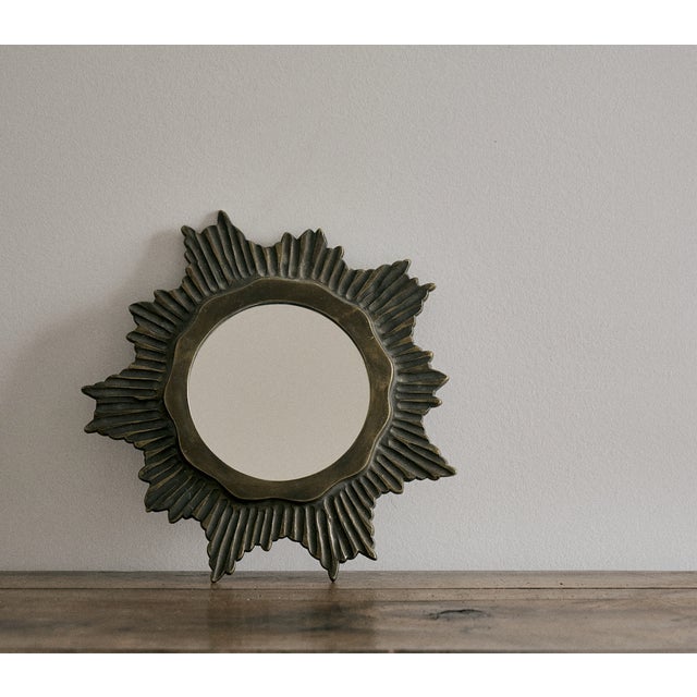 Vintage French small scale sunburst decorative wall mirror. This sunburst mirror is solid bronze has the perfect patina....
