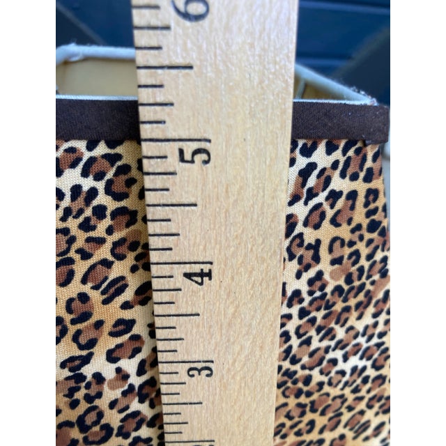 A set of4 fabric covered clip top chandelier shades. Measurements: top 3.5 bottom 6 side 5 Mary Jane McCarty Collection