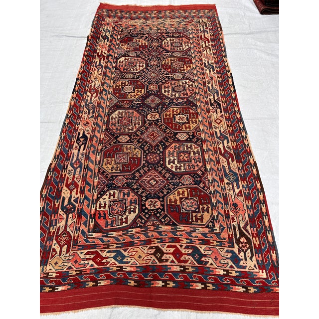 This antique hand-knotted Shirvan rug features a column of octagonal star medallions filled with small animal figures, set...