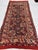 This antique hand-knotted Shirvan rug features a column of octagonal star medallions filled with small animal figures, set...