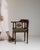 Here is a side chair, its dark mahogany, spindle back, olive upholstered seat the first thing to catch the eye. It was...
