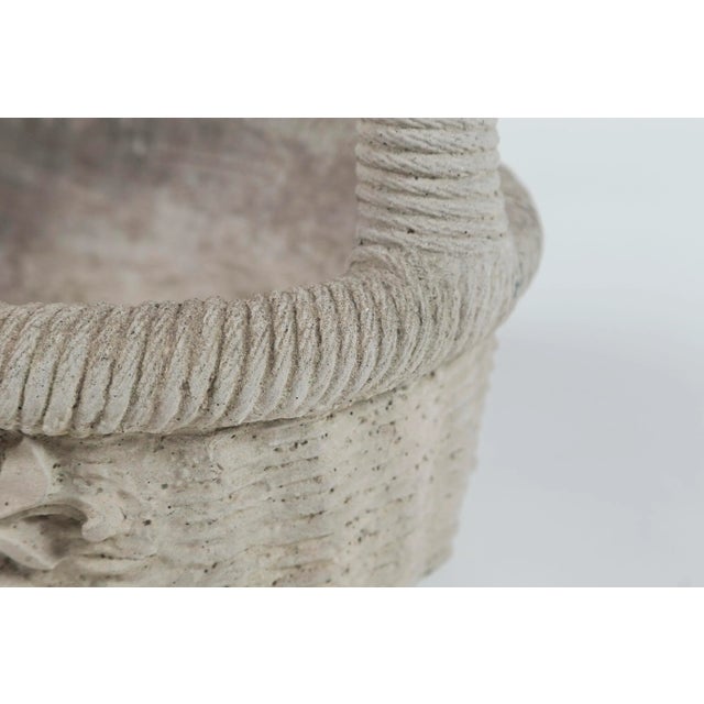 Cast cement garden basket, 20th century. Nicely detailed with overall woven rattan design and floral relief.