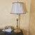 A sophisticated vintage Glenn Nelson table lamp crafted in polished brass, featuring a classic candlestick silhouette with...