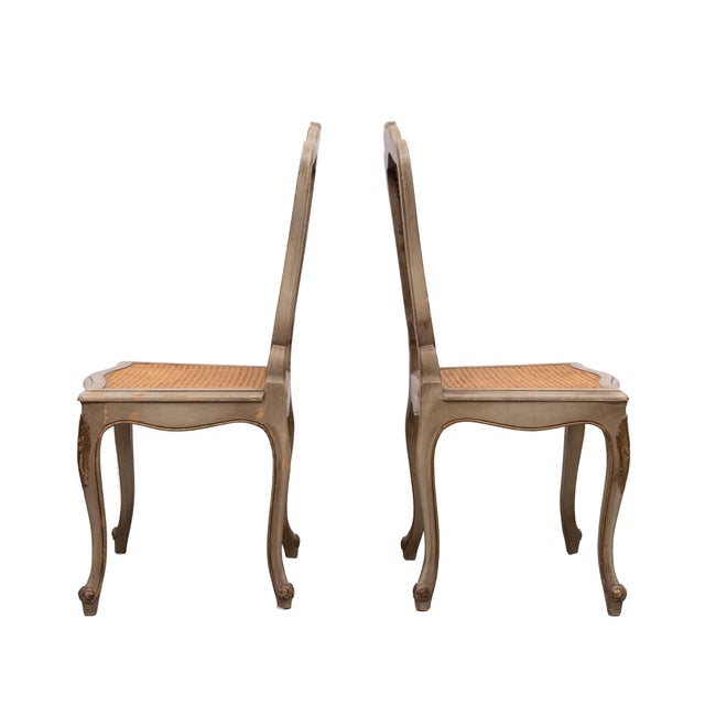 A very nicely proportioned pair of louis xv style side chairs, the foliate carved chanel moulded frames in a distressed...
