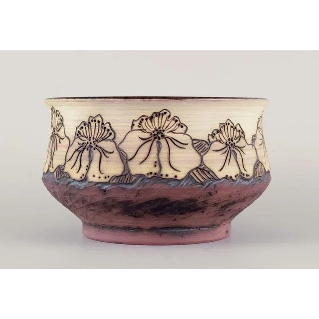 Unknown Scandinavian ceramicist. Earthenware bowl. Incised decoration with flowers. Glazed on the inside in green, blue...