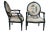 Two vintage Drexel Heritage fauteuil armchairs with French Louis XVI / Neoclassical styling that features an ebonized...