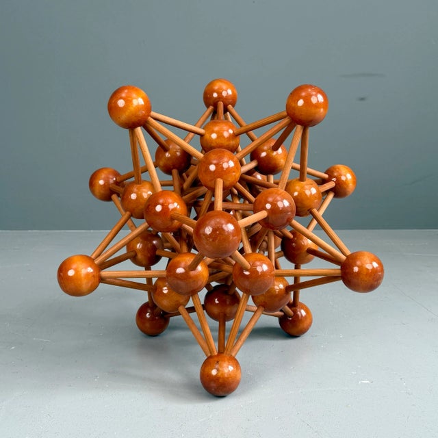 Large atom sculpture made of lacquered solid wood
