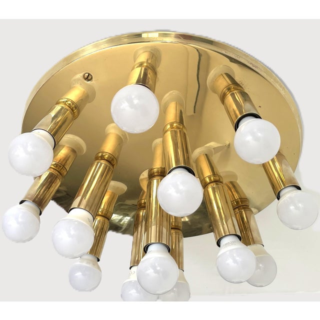 Elegant german mid-century ceiling light from the 1970s, featuring six gracefully curved brass-finished arms and six...