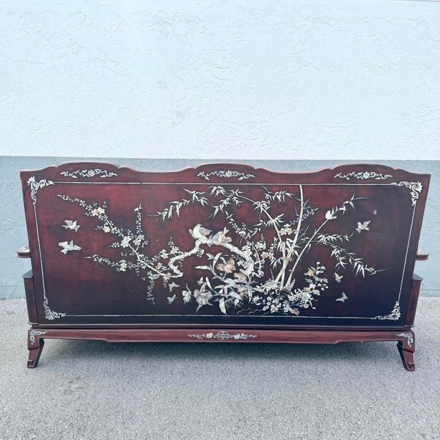 A striking blend of traditional Chinese artistry and refined craftsmanship, this vintage rosewood sofa is richly adorned...