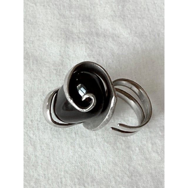 Vintage 1970s sculptural statement ring featuring a translucent smoky quartz cabochon in a dramatic asymmetrical, ribbon-...