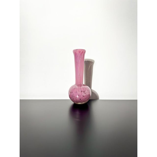 A tall stemmed bud vase, handcrafted in the late 1980s by Mdina Glass, Malta. Crafted from pink opaque glass perfectly...
