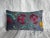A beautiful antique 1900s Suzani pillow hand-embroidered with vivid floral and vine motifs in crimson, teal, mustard, and...