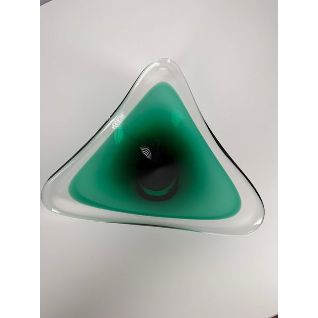 Decorative bowl made from thick art glass in the sommerso technique, combining clear glass with a deep green inner layer....